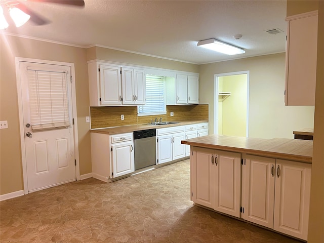 kitchen with stainless steel dishwasher, ornamental molding, ceiling fan, decorative backsplash, and white cabinets