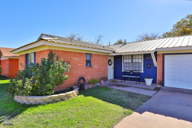 single story home with a front yard and a garage