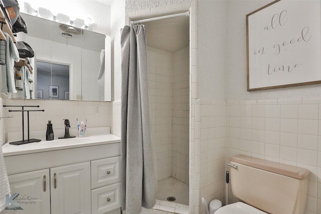 bathroom with a shower with curtain, vanity, tile walls, and toilet