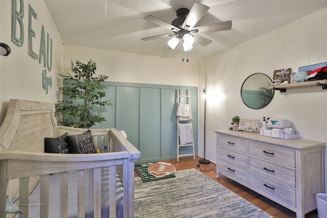 bedroom featuring ceiling fan, a closet, dark wood-type flooring, and a textured ceiling