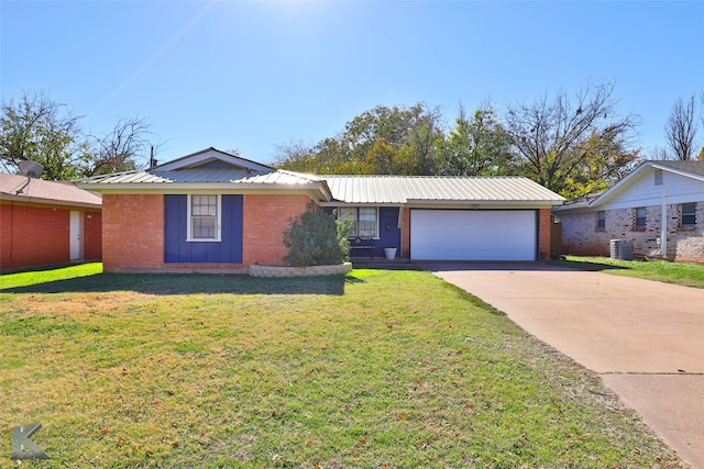 ranch-style house with a front yard, a garage, and central AC unit