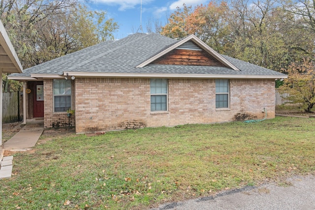 view of side of property with a yard