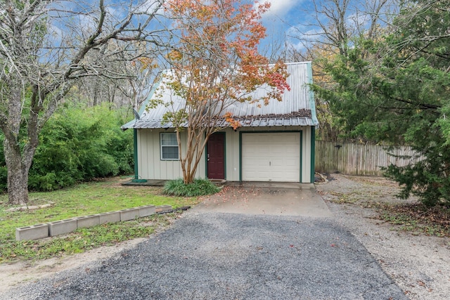 view of front of home featuring a garage and a front lawn