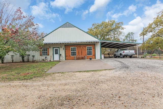 back of house featuring a carport