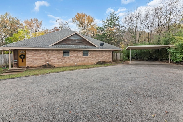 view of side of home with a carport