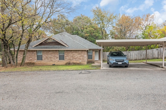 view of front of home with a carport and a front lawn