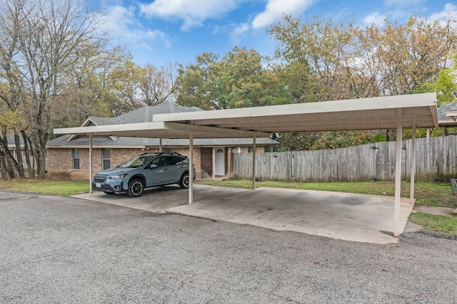 view of parking / parking lot featuring a carport