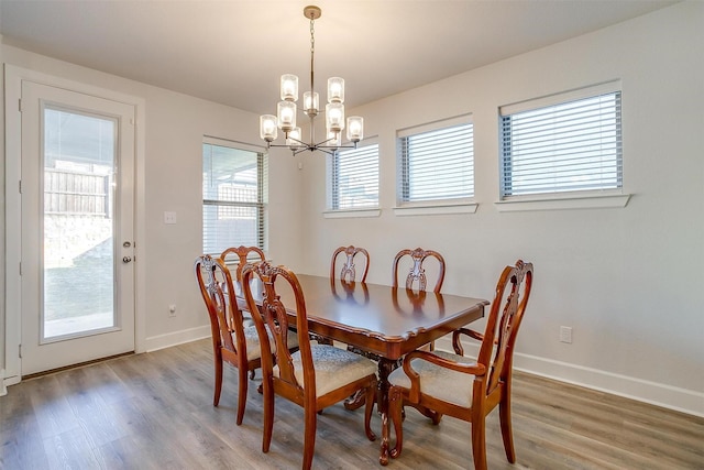 dining room with a notable chandelier and wood-type flooring