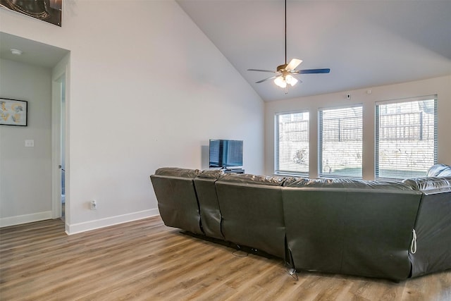 living room featuring ceiling fan, a wealth of natural light, and wood-type flooring