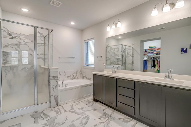 bathroom with vanity and independent shower and bath