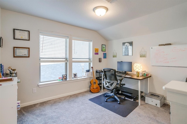 carpeted office space featuring vaulted ceiling