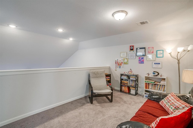 sitting room featuring vaulted ceiling and light carpet