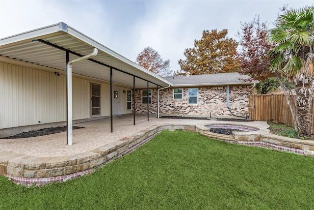 rear view of house featuring a yard and a patio