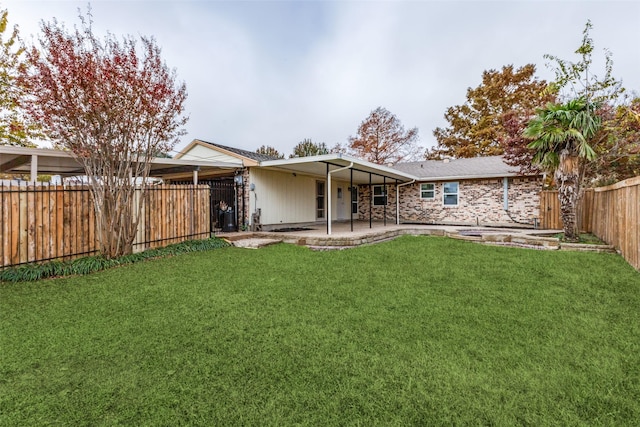 back of property featuring a yard and a patio