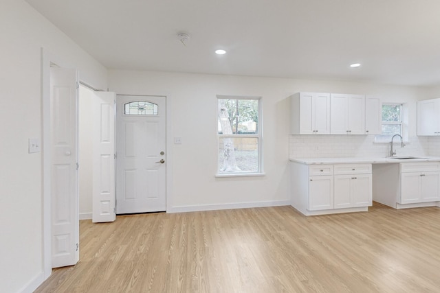 kitchen featuring white cabinetry, a healthy amount of sunlight, and sink