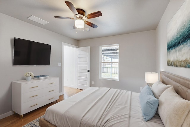 bedroom with ceiling fan and light hardwood / wood-style flooring