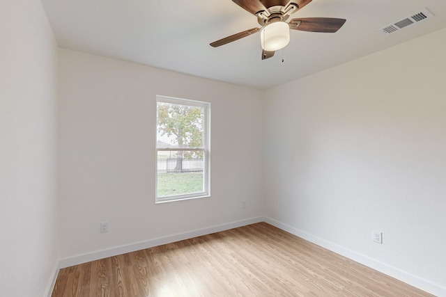 spare room featuring light hardwood / wood-style flooring and ceiling fan