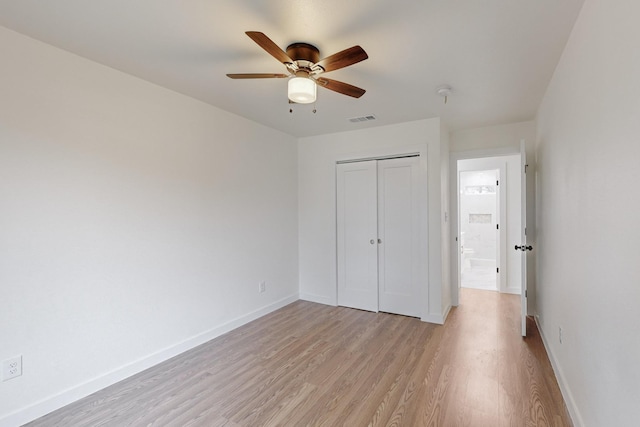 unfurnished bedroom with light wood-type flooring, a closet, and ceiling fan