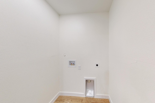 clothes washing area with electric dryer hookup, hookup for a gas dryer, hardwood / wood-style floors, and washer hookup