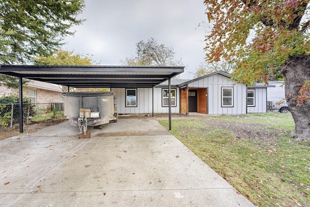 view of front of home with a front yard and a carport