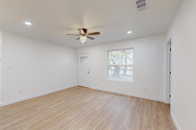 spare room with ceiling fan and light wood-type flooring