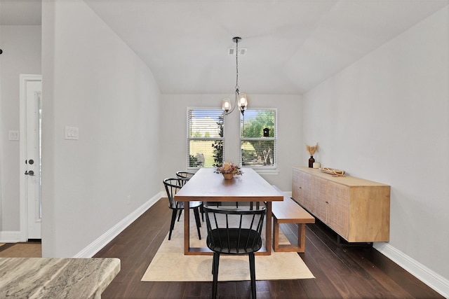 dining space featuring dark hardwood / wood-style flooring, lofted ceiling, and a notable chandelier