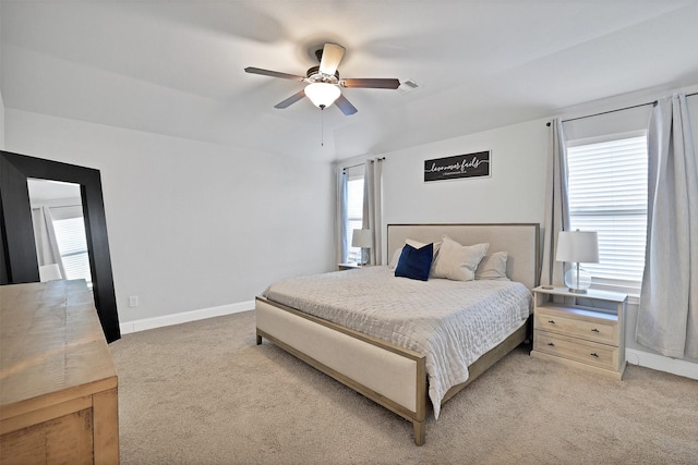 bedroom with ceiling fan and light colored carpet