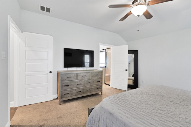 carpeted bedroom with ceiling fan, ensuite bathroom, and lofted ceiling