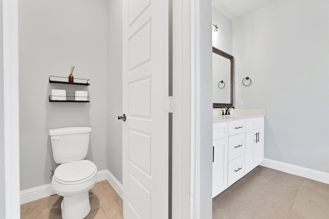 bathroom with vanity, tile patterned floors, and toilet