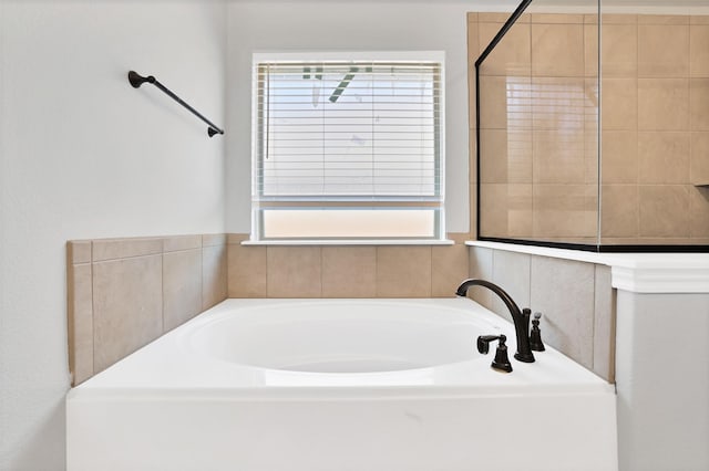 bathroom featuring separate shower and tub