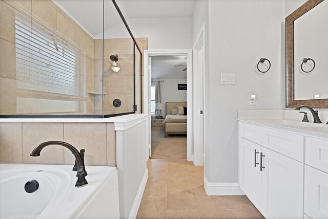 bathroom featuring vanity, tile patterned floors, and a bathing tub