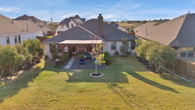 back of house featuring a lawn and a patio area