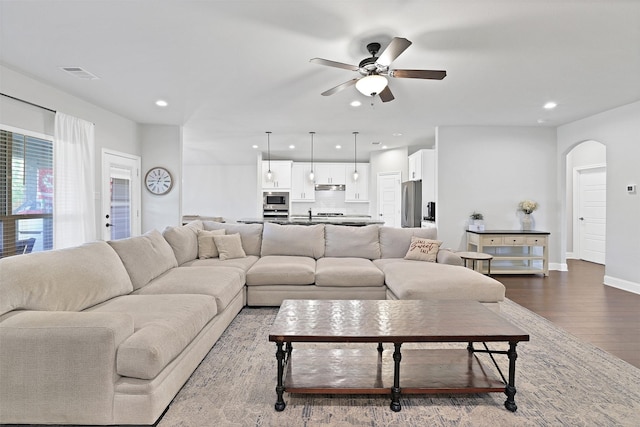 living room featuring ceiling fan and wood-type flooring