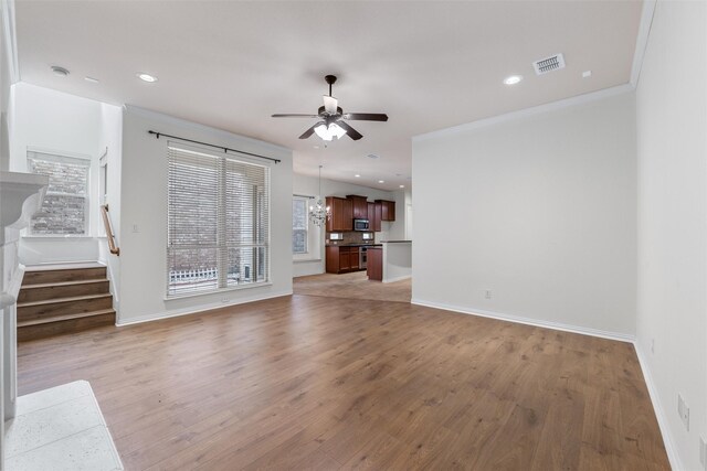 unfurnished living room with light hardwood / wood-style floors, ceiling fan, and ornamental molding