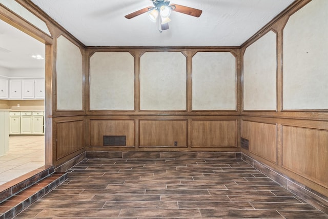 unfurnished sunroom featuring ceiling fan