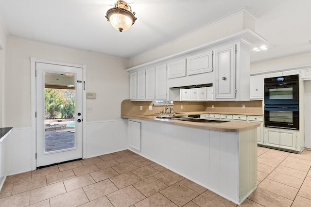 kitchen featuring white cabinetry, kitchen peninsula, black double oven, and ornamental molding