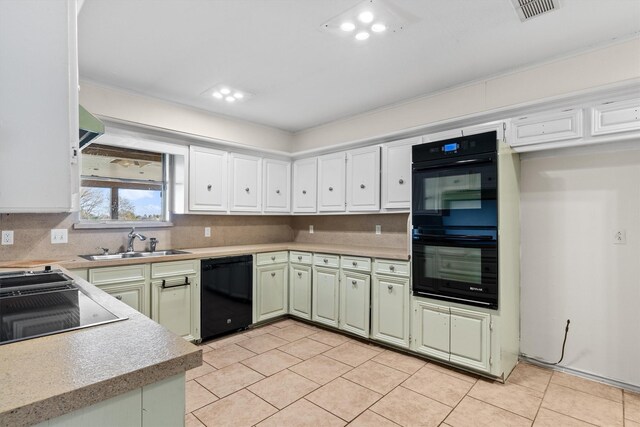 kitchen featuring black appliances, sink, green cabinetry, tasteful backsplash, and white cabinetry