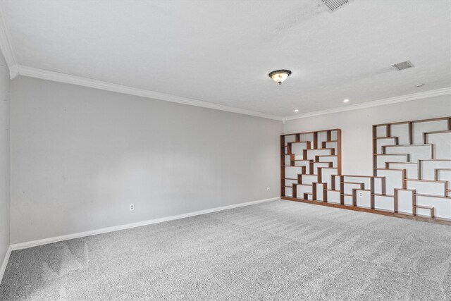 empty room featuring carpet flooring, a textured ceiling, and ornamental molding