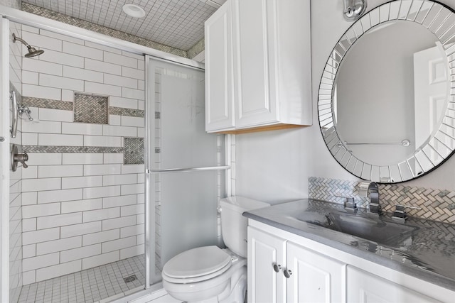 bathroom with toilet, vanity, and walk in shower