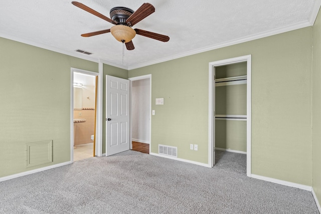 unfurnished bedroom with carpet, ceiling fan, and a textured ceiling