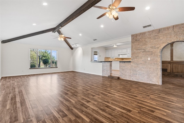 unfurnished living room with lofted ceiling with beams, ceiling fan, and dark wood-type flooring