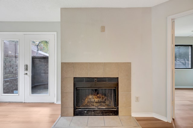 details featuring wood-type flooring, a fireplace, and french doors