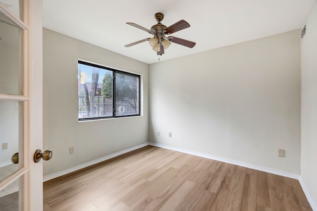 spare room featuring light hardwood / wood-style flooring and ceiling fan