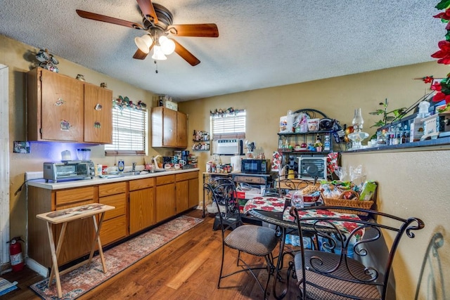 kitchen featuring a textured ceiling, dark hardwood / wood-style flooring, and ceiling fan