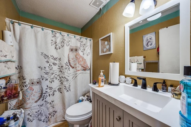 bathroom featuring vanity, a textured ceiling, toilet, and a shower with shower curtain