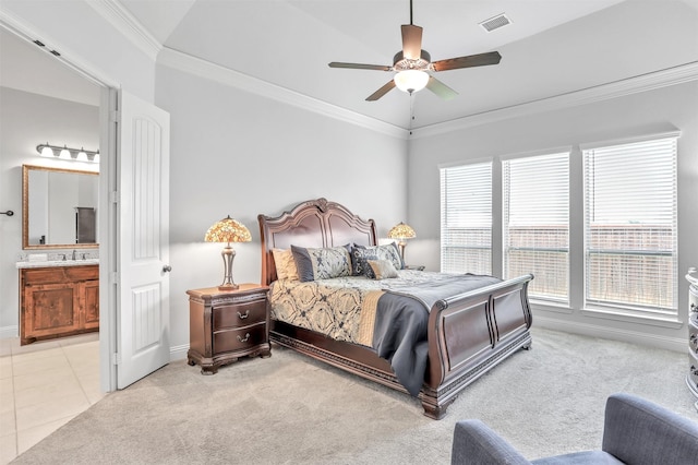 bedroom featuring light carpet, ensuite bath, multiple windows, and ceiling fan