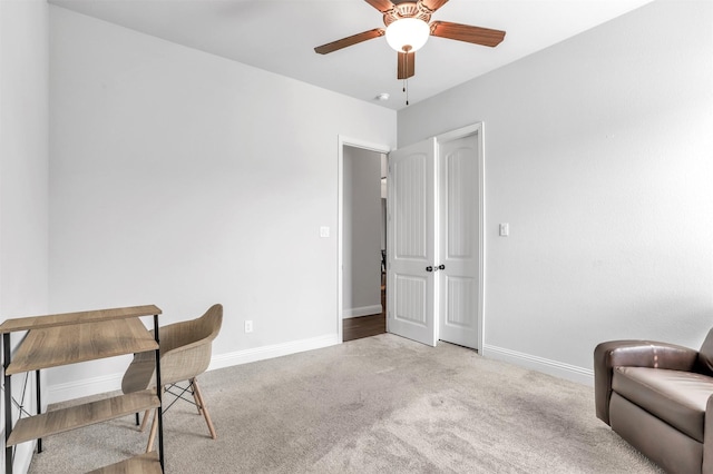 home office featuring light carpet and ceiling fan