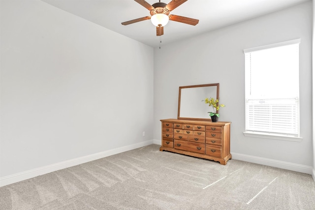 empty room with light carpet and ceiling fan