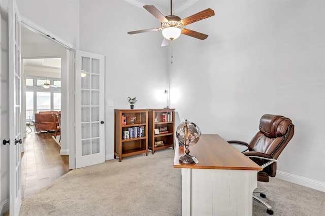 home office featuring crown molding, french doors, and light colored carpet