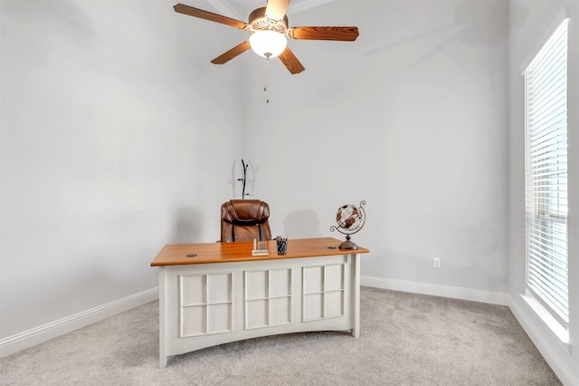 office space featuring ceiling fan and light colored carpet